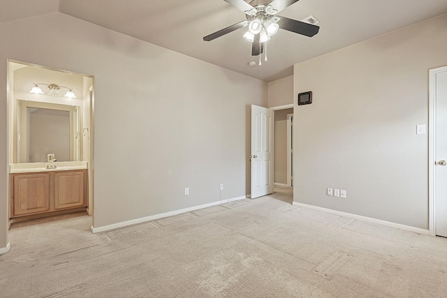 unfurnished bedroom with light carpet, connected bathroom, vaulted ceiling, and ceiling fan