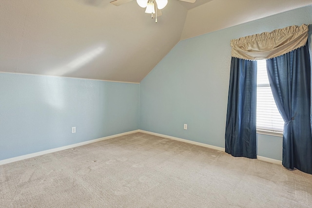 bonus room with vaulted ceiling, light carpet, and ceiling fan