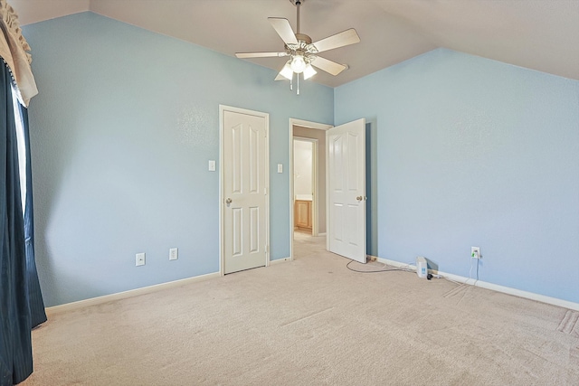 unfurnished bedroom featuring lofted ceiling, light carpet, and ceiling fan