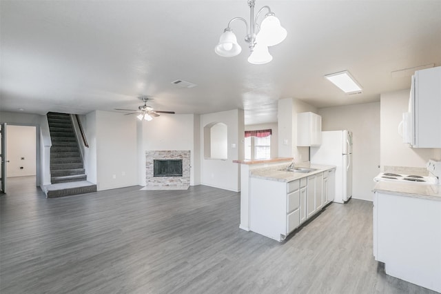 kitchen with white cabinetry, white appliances, and decorative light fixtures