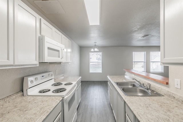 kitchen with white cabinetry, white appliances, sink, and pendant lighting