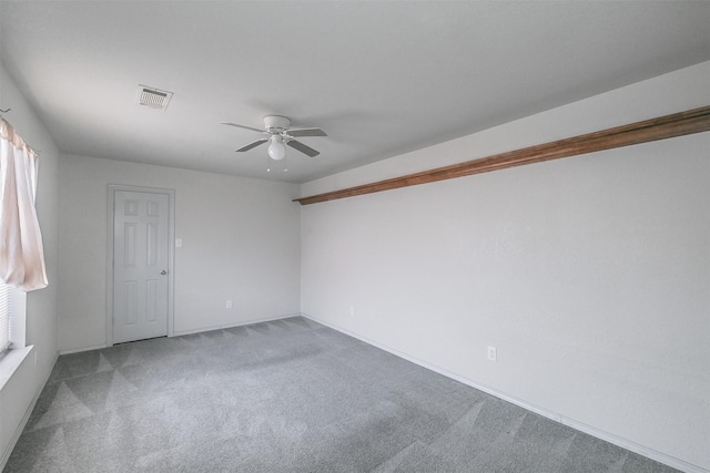 carpeted spare room with ceiling fan