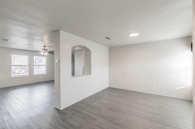 spare room featuring hardwood / wood-style flooring, ceiling fan, and a textured ceiling