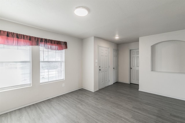 empty room featuring dark wood-type flooring