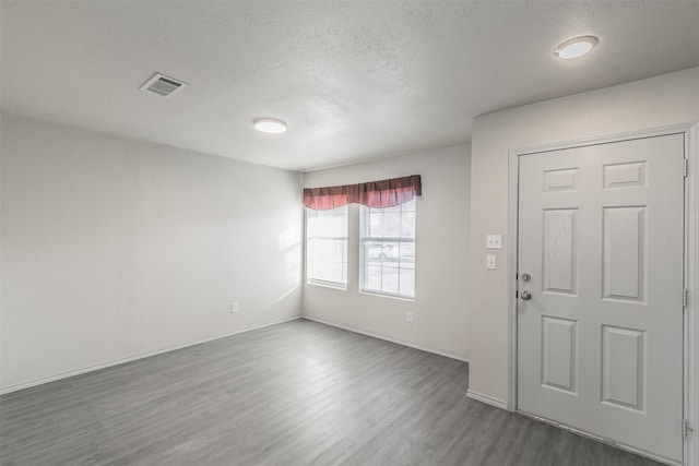 foyer entrance with a textured ceiling and hardwood / wood-style flooring