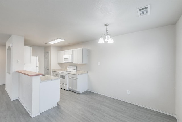 kitchen with light hardwood / wood-style floors, white appliances, white cabinets, a chandelier, and hanging light fixtures