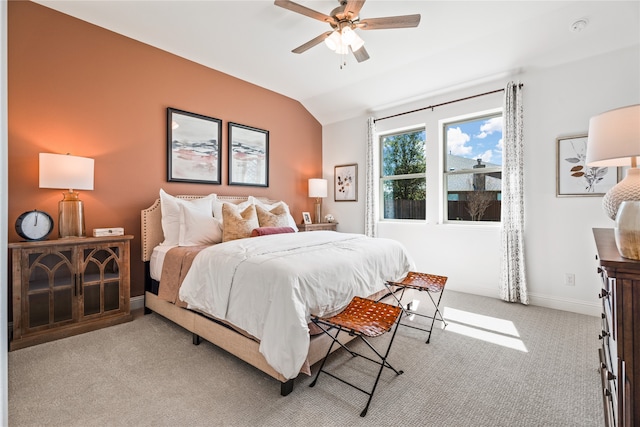 bedroom featuring vaulted ceiling, light carpet, and ceiling fan