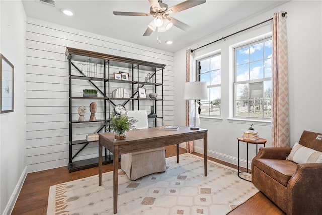 home office with wood-type flooring and ceiling fan