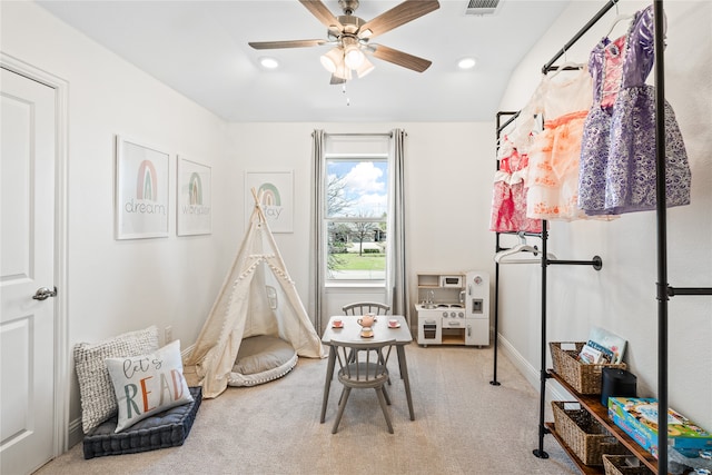 recreation room with ceiling fan and carpet