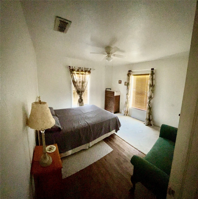 bedroom with hardwood / wood-style flooring and ceiling fan