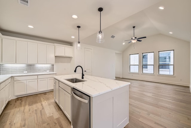 kitchen with sink, a kitchen island with sink, white cabinetry, decorative backsplash, and stainless steel dishwasher