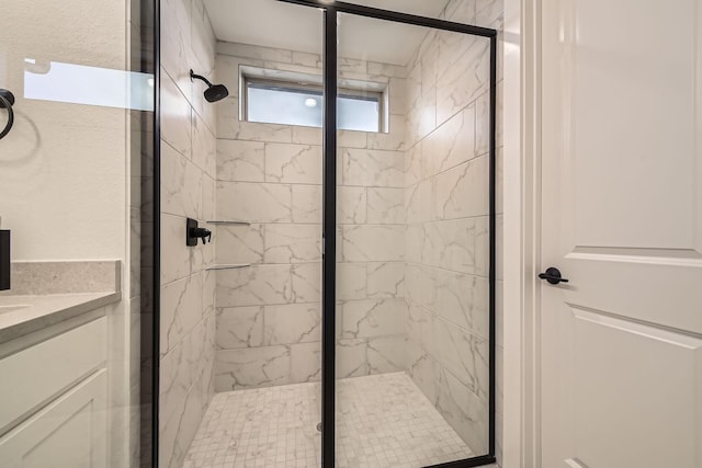 bathroom with vanity and a shower with door