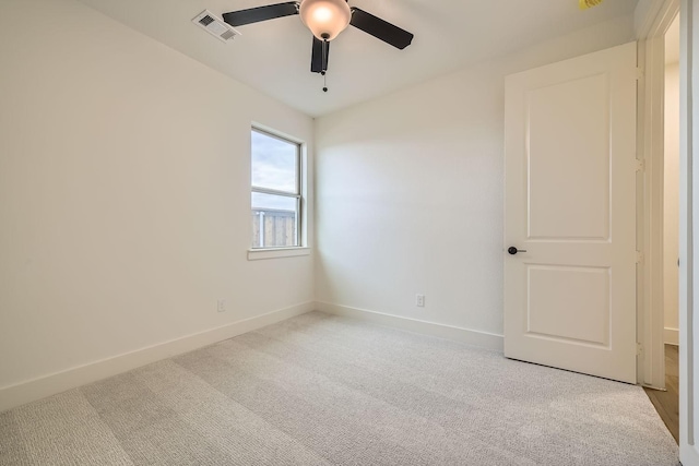 carpeted empty room featuring ceiling fan