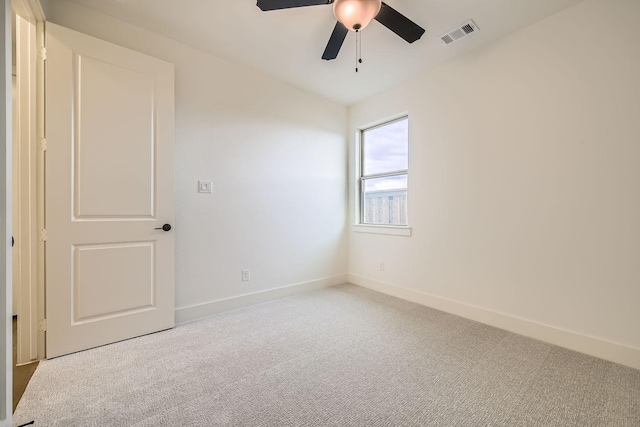 spare room with light carpet and ceiling fan