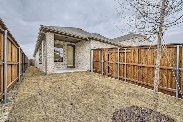 back of property with a patio