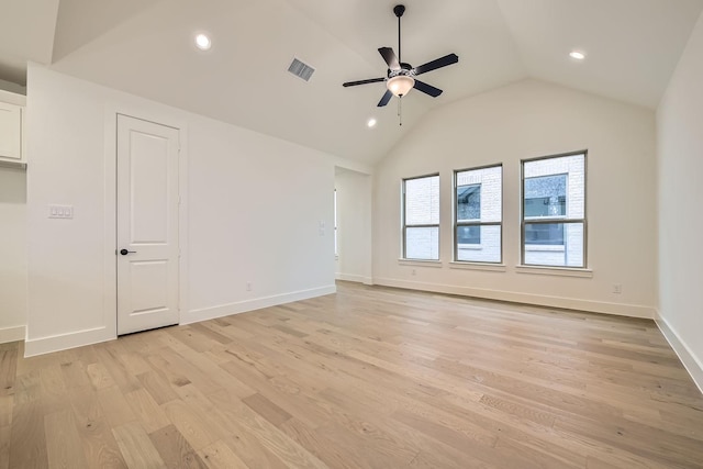 empty room featuring ceiling fan, lofted ceiling, and light hardwood / wood-style floors