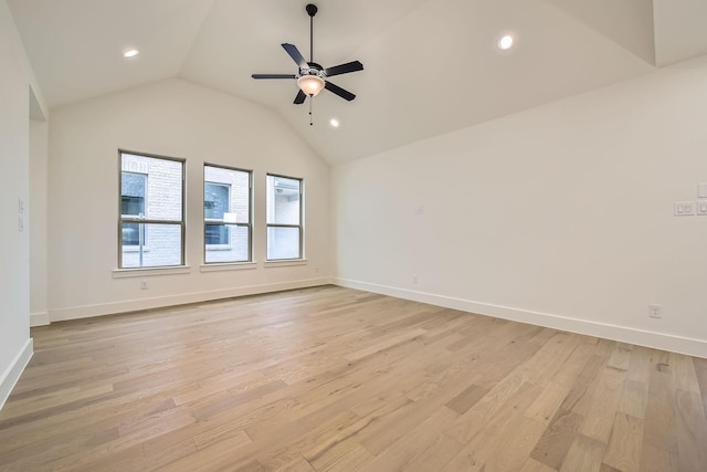 spare room featuring vaulted ceiling, ceiling fan, and light wood-type flooring