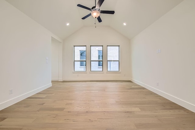 spare room with lofted ceiling, ceiling fan, and light hardwood / wood-style flooring