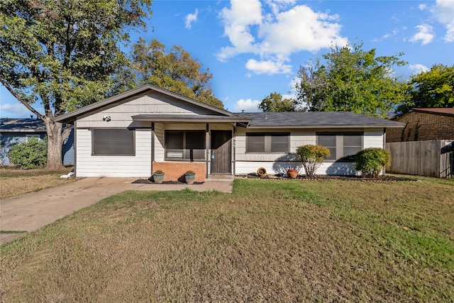 single story home featuring a front yard and a sunroom