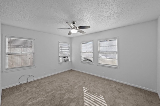 spare room with ceiling fan, a textured ceiling, light carpet, and cooling unit