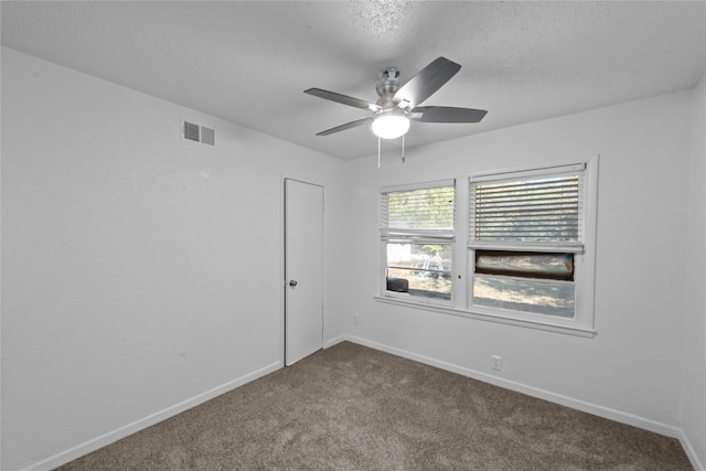 carpeted empty room featuring a textured ceiling and ceiling fan