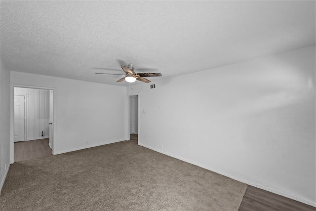 spare room with dark wood-type flooring, a textured ceiling, and ceiling fan