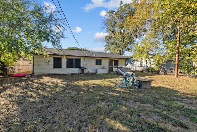 rear view of property with a yard