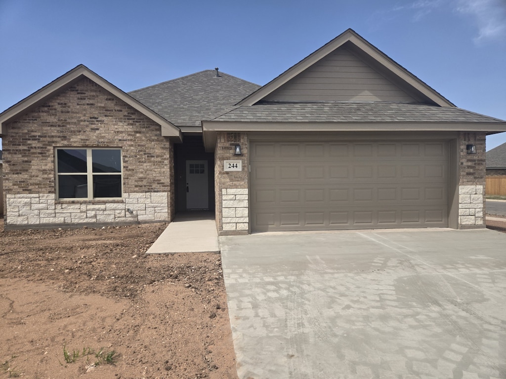 244 Morning Mist, Abilene, TX 79602 - ranch-style home with driveway, a shingled roof, a garage, and brick siding
