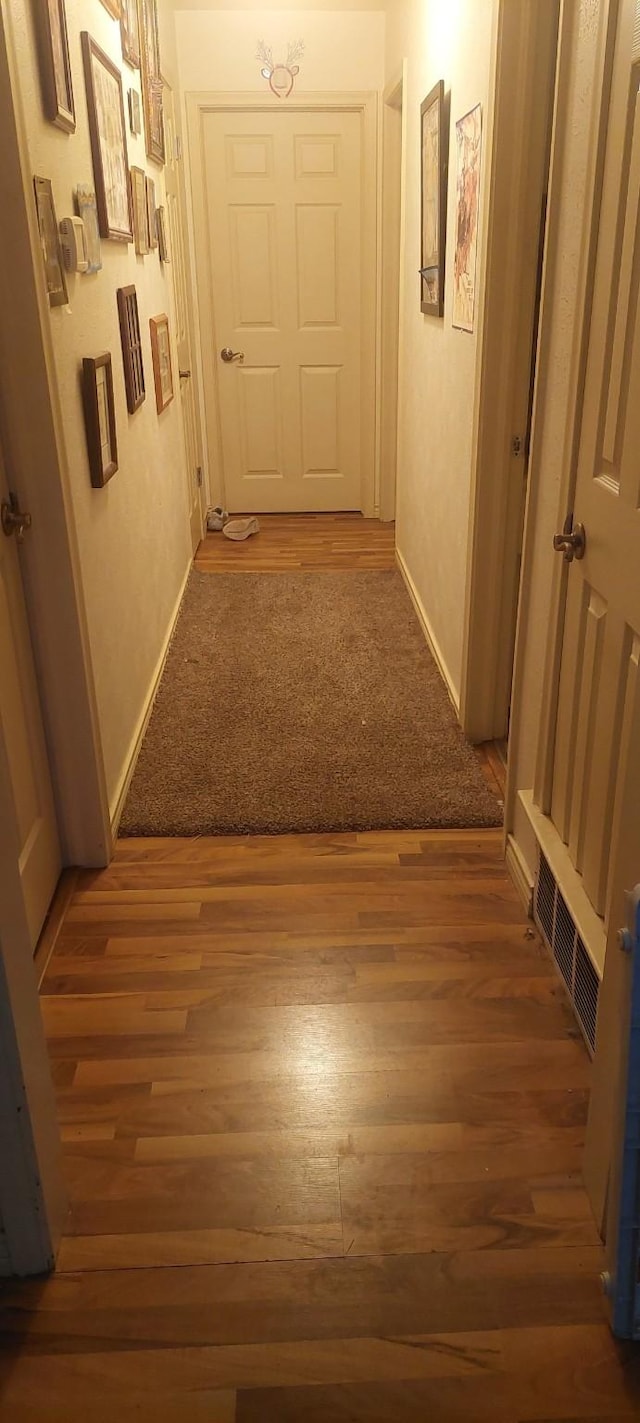 corridor with dark wood-type flooring