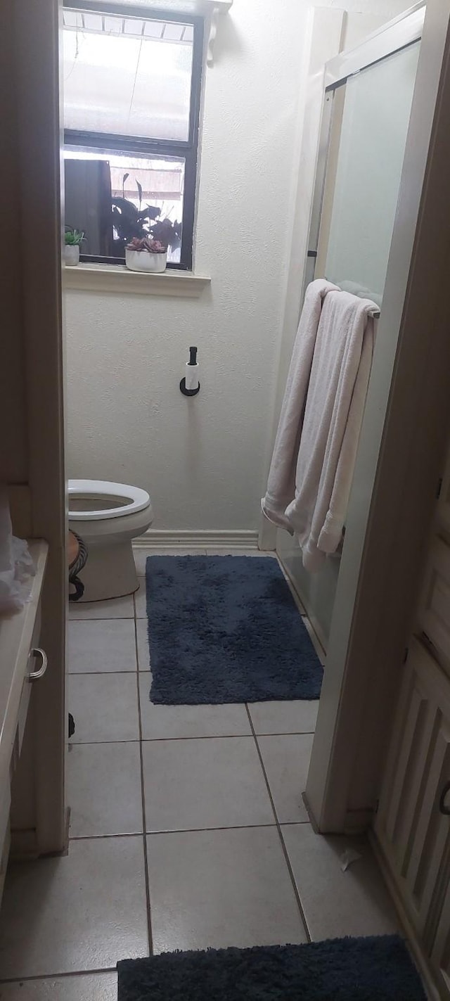 bathroom featuring tile patterned floors and toilet