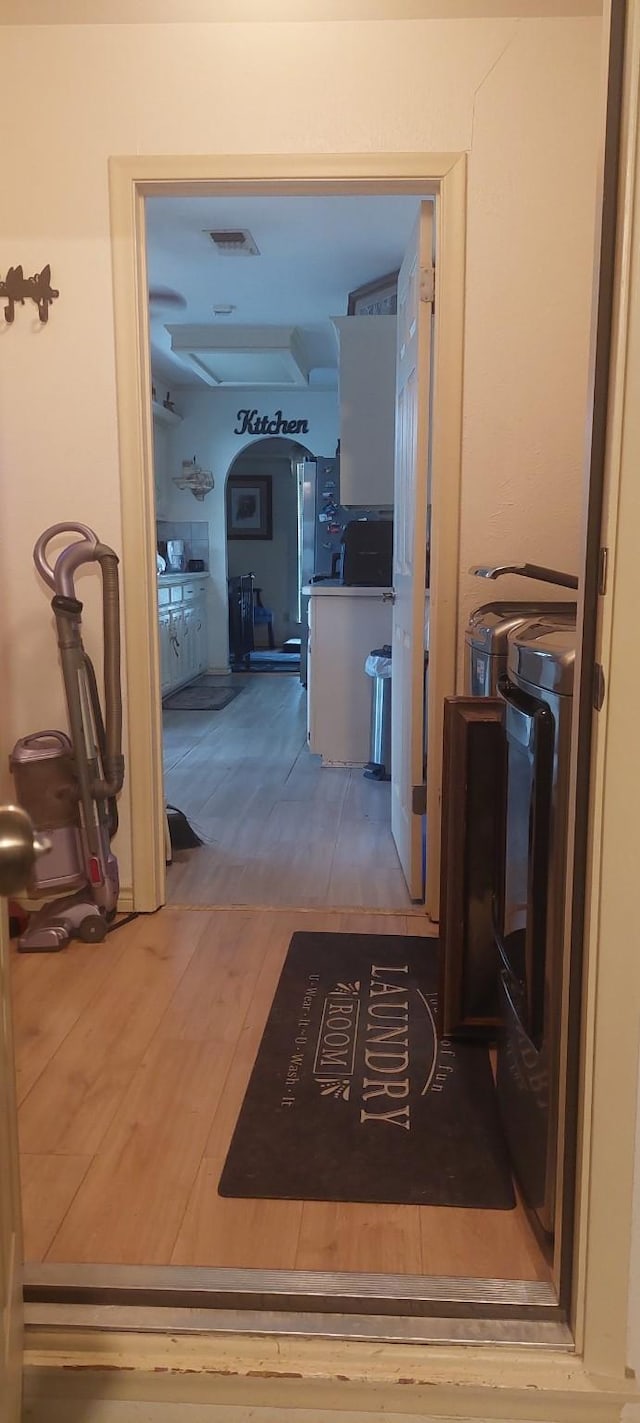 hallway with hardwood / wood-style floors