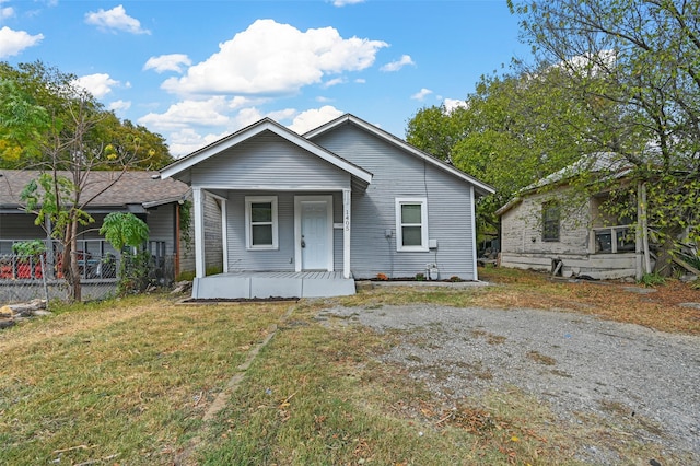 bungalow-style home with a porch and a front yard