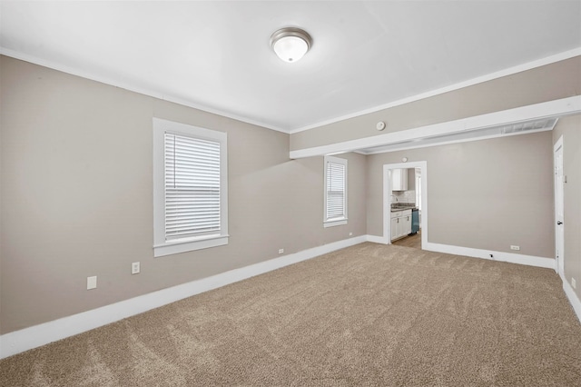 carpeted spare room with ornamental molding