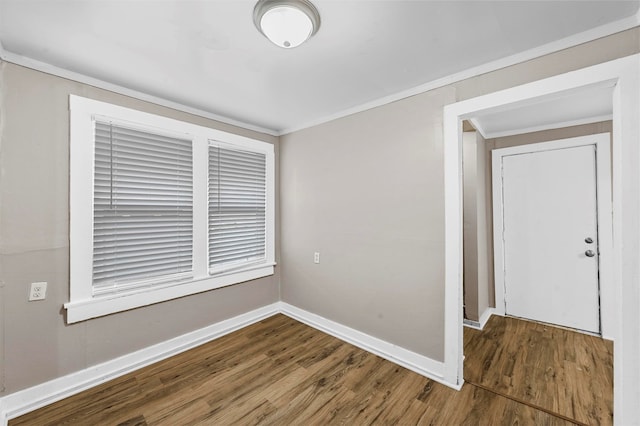 empty room featuring ornamental molding and wood-type flooring