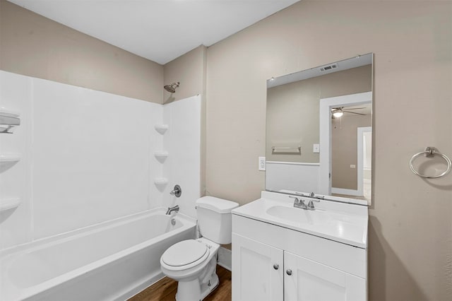 full bathroom featuring hardwood / wood-style floors, ceiling fan, toilet, vanity, and tub / shower combination