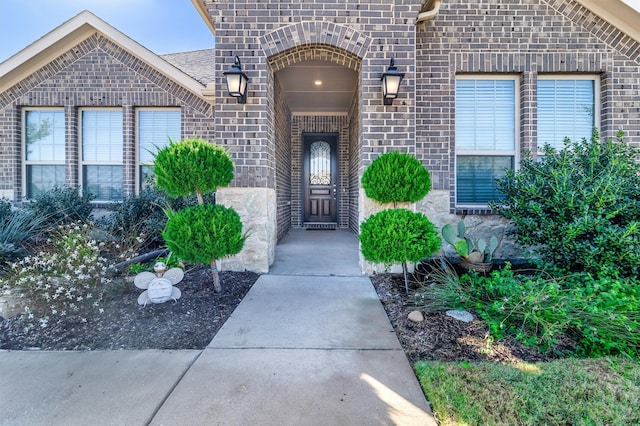 doorway to property featuring brick siding