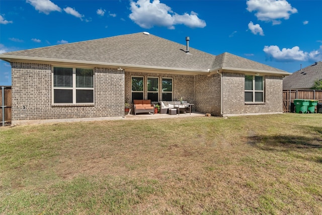 rear view of house with a patio, an outdoor living space, and a lawn