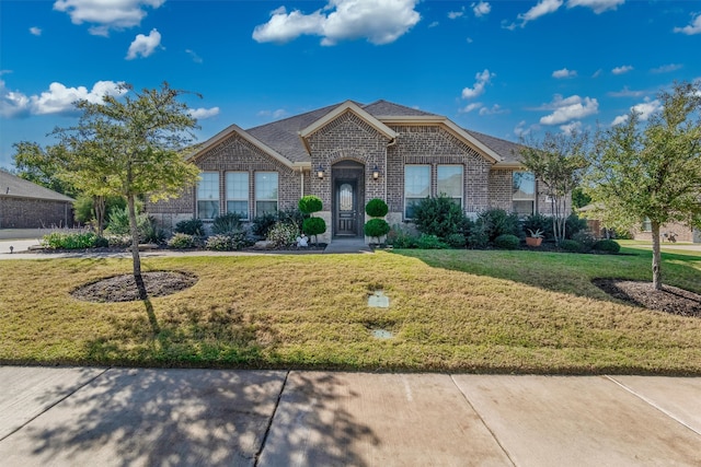 ranch-style house featuring a front lawn