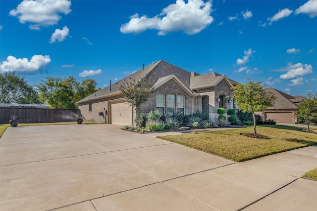 view of front of home with a front yard and a garage