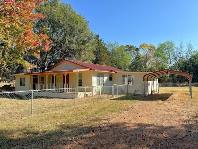 view of front facade featuring covered porch, a front yard, and a carport