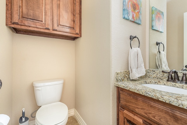 bathroom featuring toilet and vanity