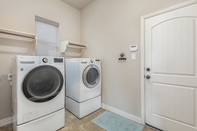 laundry room featuring washing machine and clothes dryer