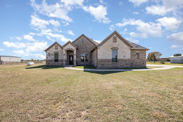 french country inspired facade with a front lawn