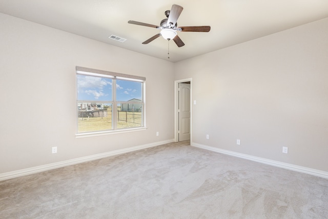 empty room featuring light carpet and ceiling fan