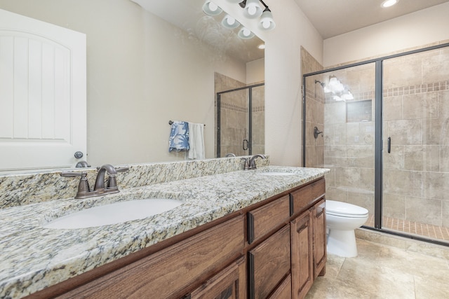 bathroom with vanity, toilet, and an enclosed shower