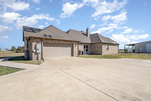 view of front of home with a garage and a front lawn