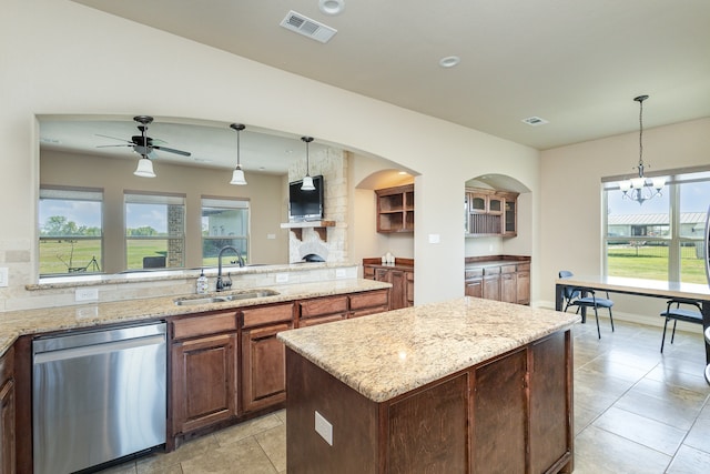 kitchen with sink, dishwasher, a center island, and decorative light fixtures