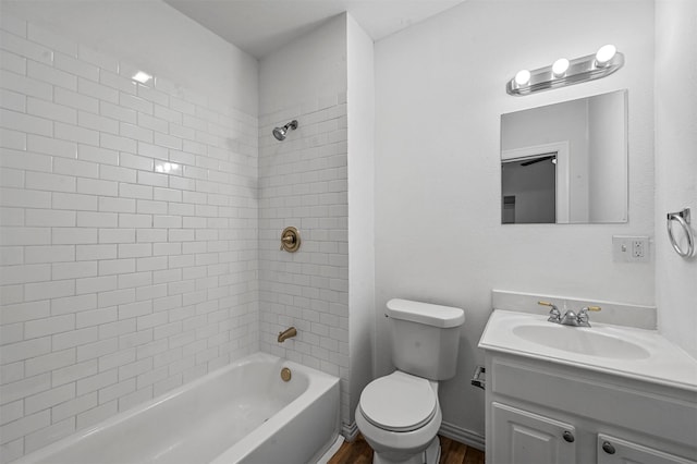 full bathroom with toilet, tiled shower / bath combo, hardwood / wood-style flooring, and vanity