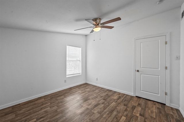 spare room featuring dark hardwood / wood-style floors and ceiling fan