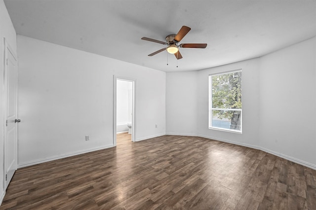 spare room featuring dark wood-type flooring and ceiling fan